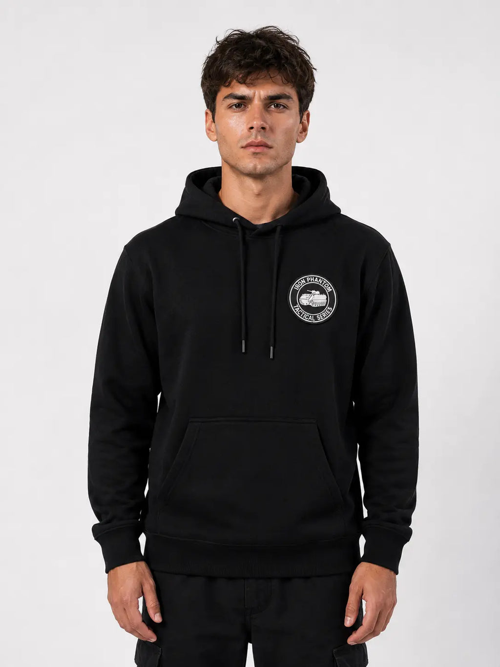 IRON PHANTOM Tactical Series Cyberpunk Armored Vehicle Hoodie - front view on male model wearing black pullover hoodie with circular tactical badge chest print, clean white studio background