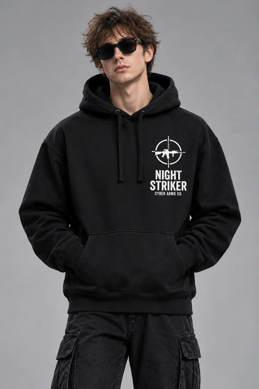 Front view of the NIGHT STRIKER Cyber Arms Co. tactical assault rifle graphic hoodie worn in an urban street setting
