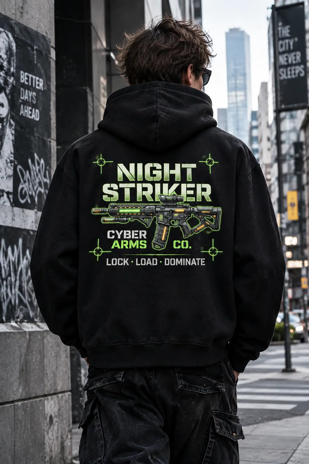 Back view of the NIGHT STRIKER Cyber Arms Co. tactical assault rifle graphic hoodie worn in an urban street setting