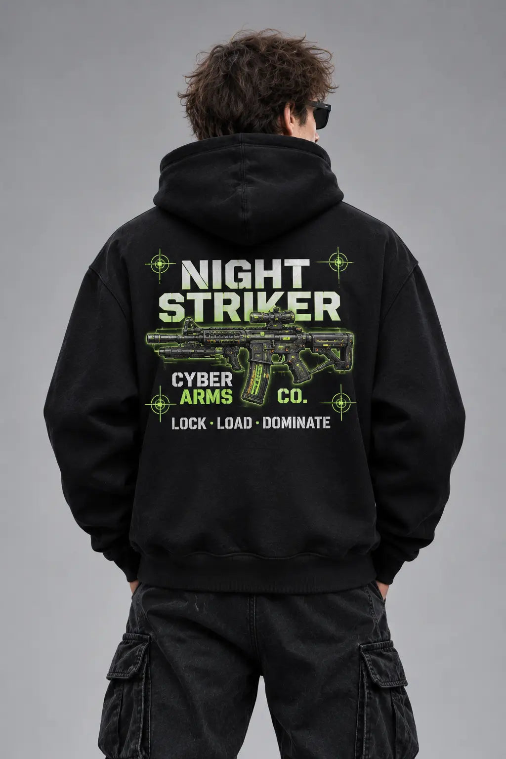 Studio back view of the NIGHT STRIKER Cyber Arms Co. tactical assault rifle graphic hoodie in black